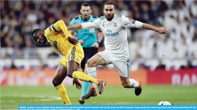  ??  ?? MADRID: Juventus’ French midfielder Blaise Matuidi (L) vies with Real Madrid’s Spanish defender Dani Carvajal during the UEFA Champions League quarter-final second leg football match between Real Madrid CF and Juventus FC at the Santiago Bernabeu...
