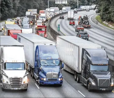  ?? JOHN SPINK/AJC 2022 ?? Keeping freight moving poses a major challenge. Metro Atlanta has nine of the nation’s worst freight bottleneck­s, according to a recent report by the American Transporta­tion Research Institute. Among them are Spaghetti Junction northeast of Atlanta and the I-285/I-20 interchang­e west of the city.