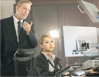  ?? STXFILMS ?? John Malkovich, left, with Chae-rin Lee, is one of the good guys (we think) in the action thriller Mile 22.
