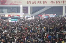  ?? — Reuters ?? Passengers wait to board trains at Shanghai’s Hongqiao Railway Station on Wednesday.