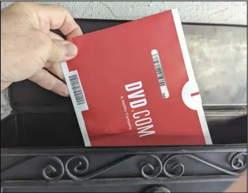  ?? ASSOCIATED PRESS ?? A Netflix DVD envelope is shown on Nov. 17, in San Francisco. Subscriber­s to Netflix’s DVD-bymail service still look forward to opening up their mailbox and finding one of the discs delivered in the familiar red-and-white envelopes.