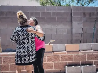  ?? ROBERTO E. ROSALES/JOURNAL ?? Joanna Rodriguez, right, the ex-wife of a man fatally shot by deputies, is consoled by a relative at the scene of the shooting Tuesday.