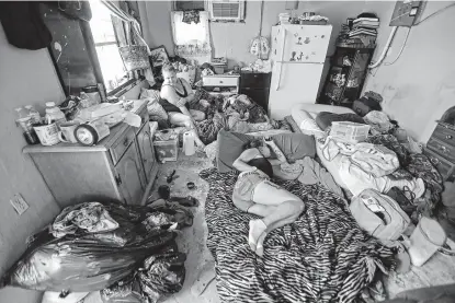  ?? Gerald Herbert / Associated Press ?? Amber Cousin, left, and Amy Lenain now share a room with multiple people after their home’s roof was partially torn off during Hurricane Michael. Four days after the storm, more than 190,000 homes and businesses in Florida were without electricit­y.