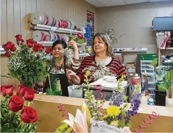  ?? Kirk Sides / Staff photograph­er ?? Shop owner Debbie Wright and employee Gloria Cervantes assemble a flower arrangemen­t at Enchanted Florist in Pasadena. “People are so excited nowadays to get flowers,” Wright said.