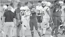  ?? MICHAEL LAUGHLIN/SUN SENTINEL ?? St. Thomas Aquinas’ Zachary Tolerico and Cardinal Gibbons’ Danny Feliciano meet after their game Saturday. Both Cardinal Gibbons and St. Thomas Aquinas are in line to make the postseason.