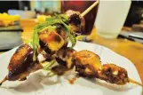  ??  ?? MERRY MIX Tako confitado or octopus skewers,