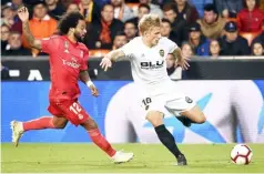  ??  ?? Real Madrid’s defender Marcelo (left) vies with Valencia’s Danish midfielder Daniel Wass during the Spanish La Liga match at the Mestalla stadium in Valencia. — AFP photo