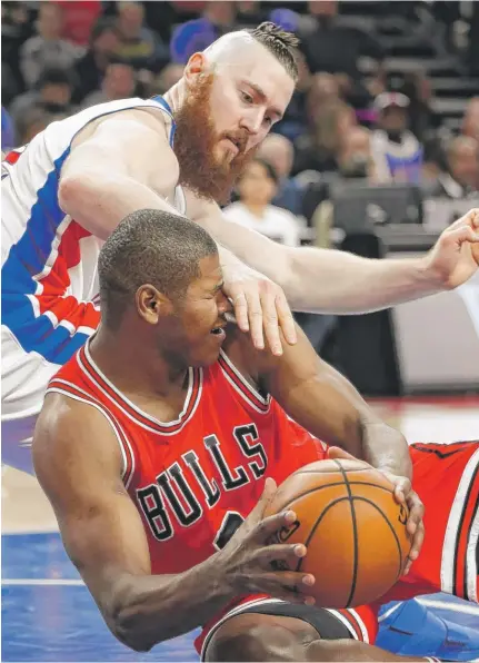  ?? | PAUL SANCYA/ AP ?? Pistons center Aron Baynes catches the Bulls’ Cristiano Felicio in the face in the first half Tuesday night in Auburn Hills, Mich.