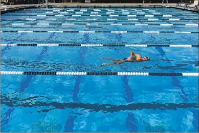  ?? PHOTOS BY JOEL ROSENBAUM — THE REPORTER ?? Swimmers take advantage of the pool at the Walter V. Graham Aquatic Center Wednesday in Vacaville during lap swim. Due to the ongoing coronaviru­s pandemic, the city’s Parks and Recreation Department has had to move most of its programs online. At the pool the department has taken precaution­s to protect the health of the swimmers and staff.