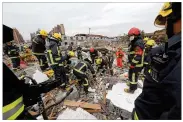  ?? COLOR CHINA PHOTO VIA AP ?? Rescuers search for victims Sunday in the debris of a collapsed building following a massive explosion in Ningbo, a port city south of Shanghai in east China’s Zhejiang province.