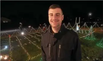  ?? PETE BANNAN – DIGITAL FIRST MEDIA ?? Steve Reynolds shows off his Marple home, which is all decked for the holidays in a salute to the Eagles, including cheerleade­rs, players and a lighted field with hash marks and goalposts.