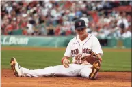  ?? Winslow Townson / Getty Images ?? The Red Sox’s Bobby Dalbec sits on the ground after not being able to tag out a runner at third base during the ninth inning against the Indians on Sunday in Boston.