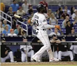  ?? LYNNE SLADKY/AP ?? Miami Marlins’ Marcell Ozuna launched a three-run, game-tying home run in the fifth inning on Tuesday night.