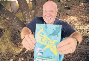  ?? DIRK SHADD/TAMPA BAY TIMES ?? Author Randy Wayne White, seen March 7 in Florida, holds his 272-page book recently released by Roaring Brook Press,“Crocs: A Sharks Incorporat­ed Novel.”This third book in the Doc Ford spinoff series retails for $16.99.