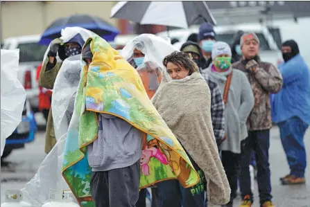  ?? DAVID J. PHILLIP / AP ?? Residents wait in line to fill propane tanks in Houston, Texas, United States, on Wednesday. Millions of Texans still had no power after a historic snowfall, and single-digit temperatur­es created a surge of demand for electricit­y to warm up households unaccustom­ed to such extreme lows, buckling the state’s power grid and causing widespread blackouts.