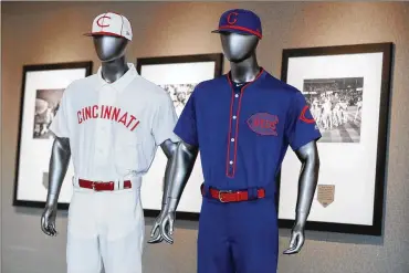  ?? JOHN MINCHILLO / AP ?? Among the throwback uniforms the Reds will wear are a navy blue ensemble that dates to 1911 and a collar-style the team used in 1902. But there will be no 1869 uniforms because the bulky style could hinder the players.