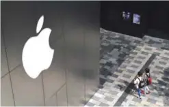  ??  ?? BEIJING: People walk past an Apple store in Beijing.—AFP