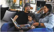  ?? Lea Suzuki / The Chronicle ?? Michael Franti and wife Sara Agah Franti read together with son Taj, then 17 months, in February.