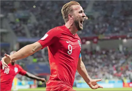  ?? THANASSIS STAVRAKIS/AP PHOTO ?? Harry Kane celebrates after scoring the tie-breaking goal in extra time to lift England to a 2-1 victory over Tunisia in a Group G match at the World Cup on Monday night in Volgograd, Russia.