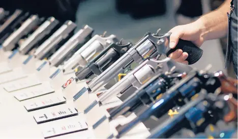  ?? JOHN LOCHER/AP 2016 ?? Handguns are displayed at a trade show in Las Vegas. The gunman accused in last week’s deadly shootings at three Atlanta-area businesses legally purchased a 9 mm handgun hours before the rampage. Georgia does not have a waiting period.