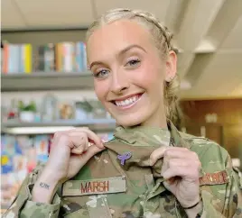  ?? COURTESY OF THE DEPARTMENT OF DEFENSE ?? Air Force 2nd Lt. Madison Marsh proudly shows off her purple ribbon lapel pin symbolizin­g pancreatic cancer awareness, a disease her mother died from in 2018.