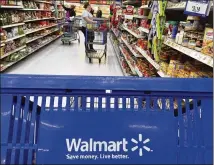  ?? ELISE AMENDOLA / AP 2017 ?? Customers shop for groceries at a Salem, N.H., Walmart. The Arkansas retailer’s sales rose to $136.3B.