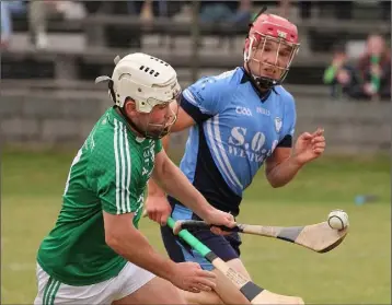  ??  ?? David O’Brien of Naomh Eanna races clear of Seamus Mythen (St. Anne’s).