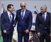  ?? EVAN VUCCI — THE ASSOCIATED PRESS ?? President Joe Biden stands with Israeli President Isaac Herzog, left,,and Prime Minister Yair Lapid after arriving at Ben Gurion Airport on Wednesday in Tel Aviv, Israel.