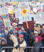  ?? GREG SORBER/JOURNAL ?? Lorri Burnett of El Paso, left, and Cathy McManus, of Cedar Grove, N.M., right, hold signs of protest Sunday at the Women’s March on Civic Plaza.