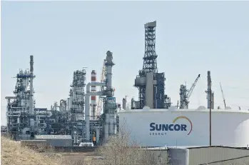  ?? JASON FRANSON/THE CANADIAN PRESS ?? The Suncor Energy Inc. refinery in Edmonton. Suncor increased its dividend by one cent to $0.29 a share, while other producers such as Cenovus Energy Inc. and Royal Dutch Shell are announcing job cuts.