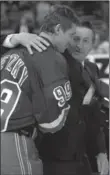  ??  ?? New York Rangers’ Wayne Gretzky is embraced by his father, Walter, prior to the start of No. 99’s last game in the NHL, 18 years ago today.