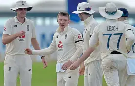  ??  ?? Fist bump: Bess (second left) enjoys his haul with Broad and Co