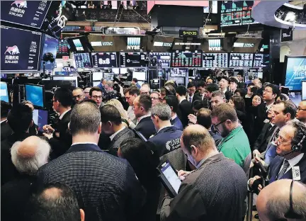  ?? SPENCER PLATT/GETTY IMAGES ?? Fears of another 2008-like stock market meltdown are in the air. On Friday, a day after trade war fears with China spurred a massive loss, traders and employees of Sunlands Online Education gather at the New York Stock Exchange during the Beijing-based...