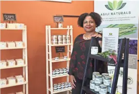  ?? MICHAEL SEARS / MILWAUKEE JOURNAL SENTINEL ?? Trenise Watson of Asili Naturals sells skin and body care products in her space in the former Outpost Foods building at 1617 W. North Ave., in the Marketplac­e Business Improvemen­t District.