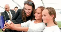  ?? GETTY IMAGES ?? Now that’s good light. Prime Minister Jacinda Ardern agrees to a selfie with children during centenary celebratio­ns at Ratana Church.