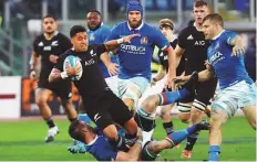  ?? Reuters ?? New Zealand’s Te Toiroa Tahurioran­gi attempts to get away from the pack during the game against Italy yesterday.