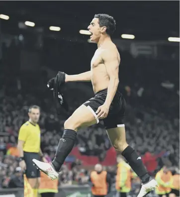  ??  ?? 0 Wissam Ben Yedder pulls off his shirt in celebratio­n after scoring Sevilla’s second goal.