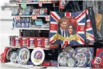  ?? Picture: AFP ?? CASHING IN: Memorabili­a marking Saturday’s wedding between Prince Harry and Meghan Markle on display in central London