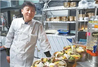  ?? Courtesy of Jung Sung-san ?? Jung Sung-san, a film and musical director from North Korea, poses in the kitchen of his restaurant in Incheon. Now as a restaurate­ur, Jung offers dishes of his hometown Pyongyang such as cold noodles.