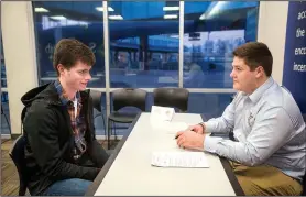  ?? NWA Democrat-Gazette/BEN GOFF • @NWABENGOFF ?? Jake Youngs (left) of Rogers sits down for an interview Thursday with Tyler Burson, Northwest Arkansas Naturals clubhouse assistant, during the annual Northwest Arkansas Naturals job fair at Arvest Ballpark in Springdale. Springdale residents approved...