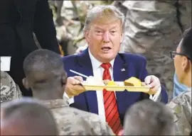  ??  ?? THE PRESIDENT helped serve troops Thanksgivi­ng dinner in Afghanista­n. His only other trip to a war zone came on a visit to Iraq around Christmas last year.