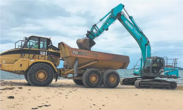  ??  ?? RESTORATIO­N WORK: Cassowary Coast Regional Council workers repair the jetty and sand erosion at Dunk Island this week.