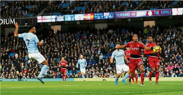  ??  ?? Solid display: Raheem Sterling (left) scoring Manchester City’s first goal against Watford in the Premier League match at the Etihad on Tuesday. City won 3-1. — Reuters