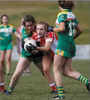  ??  ?? Louth Marie Claire Rogers breaks through an Offaly sandwich.