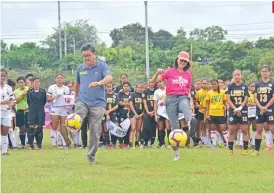  ?? SUNSTAR FOTO / MACKY LIM ?? CEREMONIAL KICK. Taguig City Representa­tive Pia Cayetano and South Davao Regional Football Associatio­n (SDRFA) official Edgar Te lead the ceremonial kick of the 4th Pinay in Action (PIA) tournament at Tionko field in Davao City yesterday.