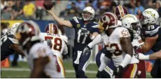  ??  ?? Los Angeles Chargers quarterbac­k Philip Rivers throws a pass during the first half of an NFL football game against the Washington Redskins on Sunday in Carson. AP PHOTO