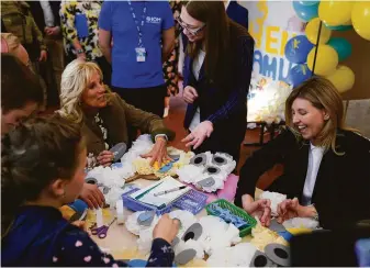  ?? Susan Walsh / Associated Press ?? First lady Jill Biden (left) and Olena Zelenska (right), wife of Ukrainian President Volodymyr Zelenskyy, join children making Mother’s Day gifts at a school in the town of Uzhhorod.