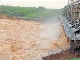  ?? PTI PHOTO ?? The water level rises above the danger mark in Sipu dam in Deesa, Gujarat, on Wednesday. The state government has said 31 of the state’s 209 reservoirs have been out on high alert.