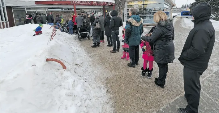  ?? JOHN LUCAS/EDMONTON JOURNAL ?? The lineup for flu shots at the Bonnie Doon Public Health Centre on Wednesday stretched out onto the sidewalk as dozens of people waited in chilly temperatur­es.