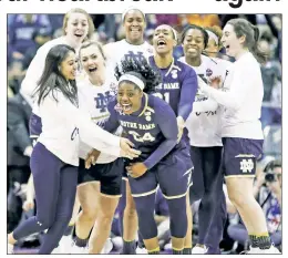  ?? Getty Images ?? LATE LATE SHOW: Arike Ogunbowale celebrates with her teammates after hitting the game-winning shot with one second left in Notre Dame’s 91-89 overtime win over UConn on Friday